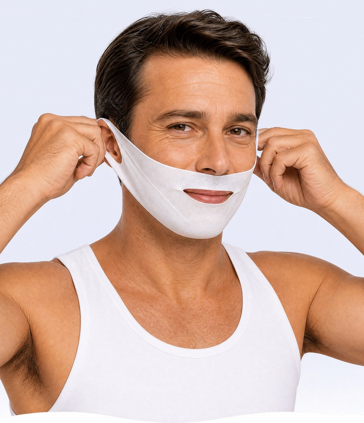 Woman applying a white facial mask with ear loops.
